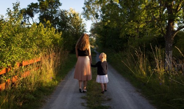 mother and daughter walking on the road